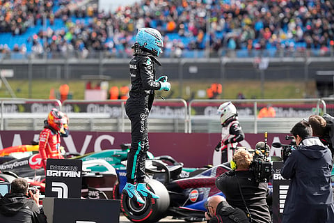 George Russell celebrates after setting the pole position 